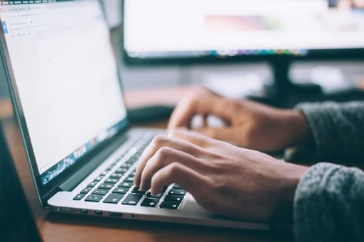 Person writing a US invitation letter using their laptop