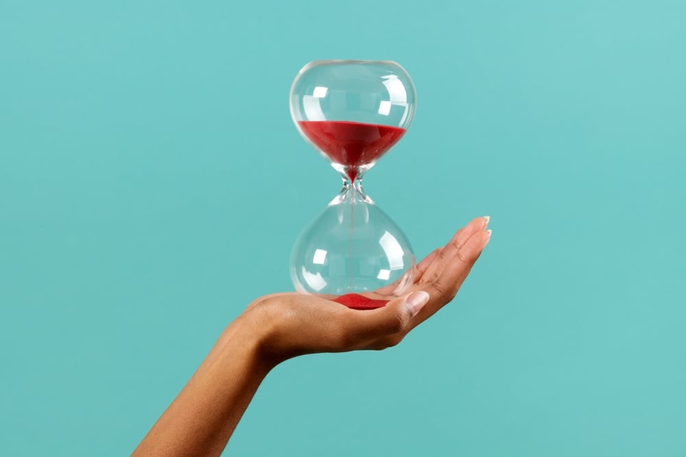 Woman hand holding an hourglass