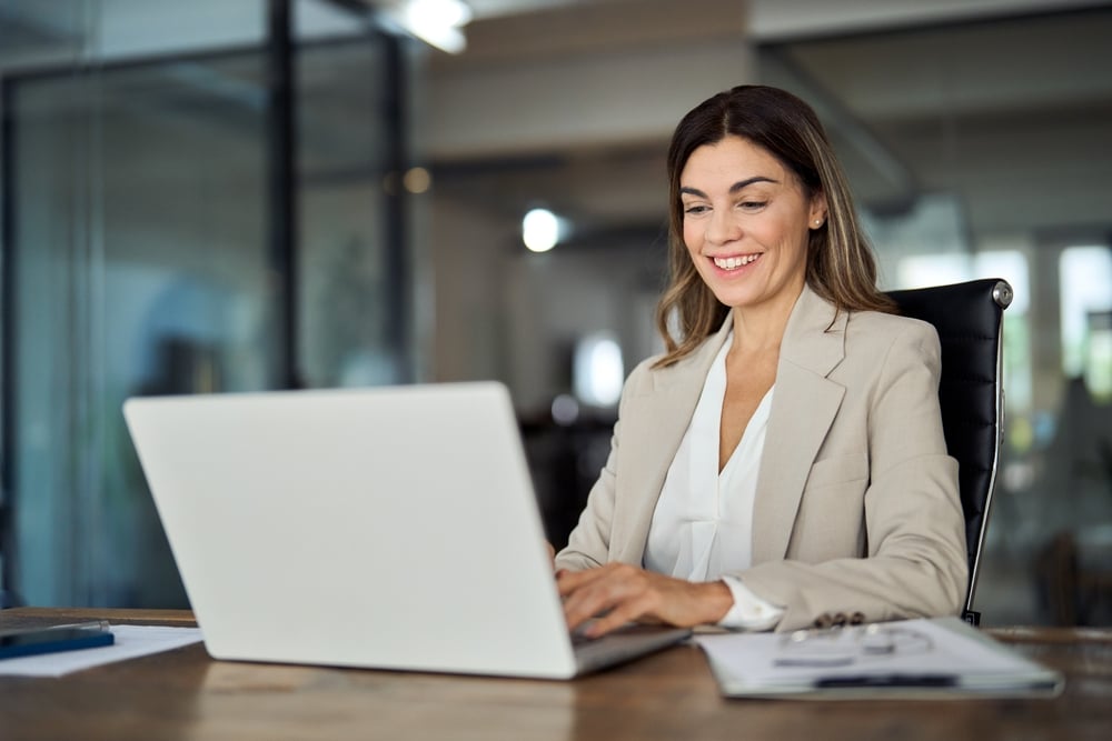 Hispanic business woman on laptop