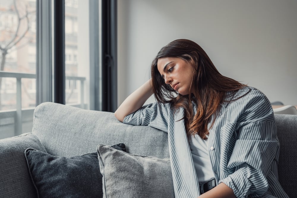 Distressed woman waiting on sofa