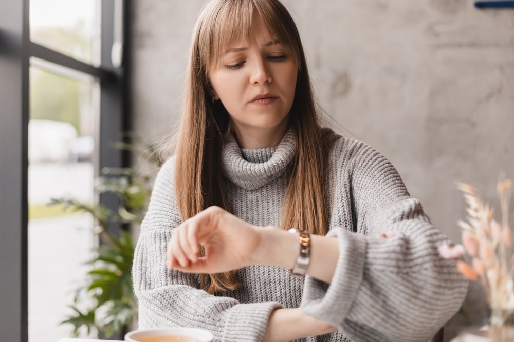 woman checking watch for time