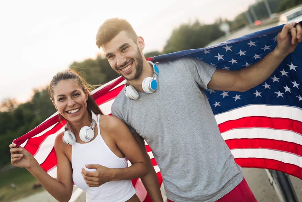 brother sister holding us flag for visa sponsorship