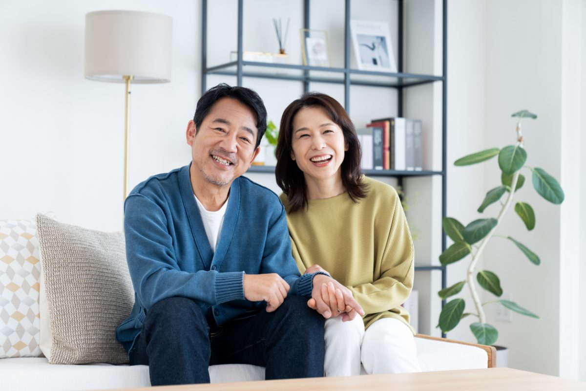A couple relaxing in the living room of their home.