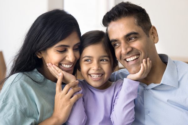 Closeup of a happy child between her father and mother