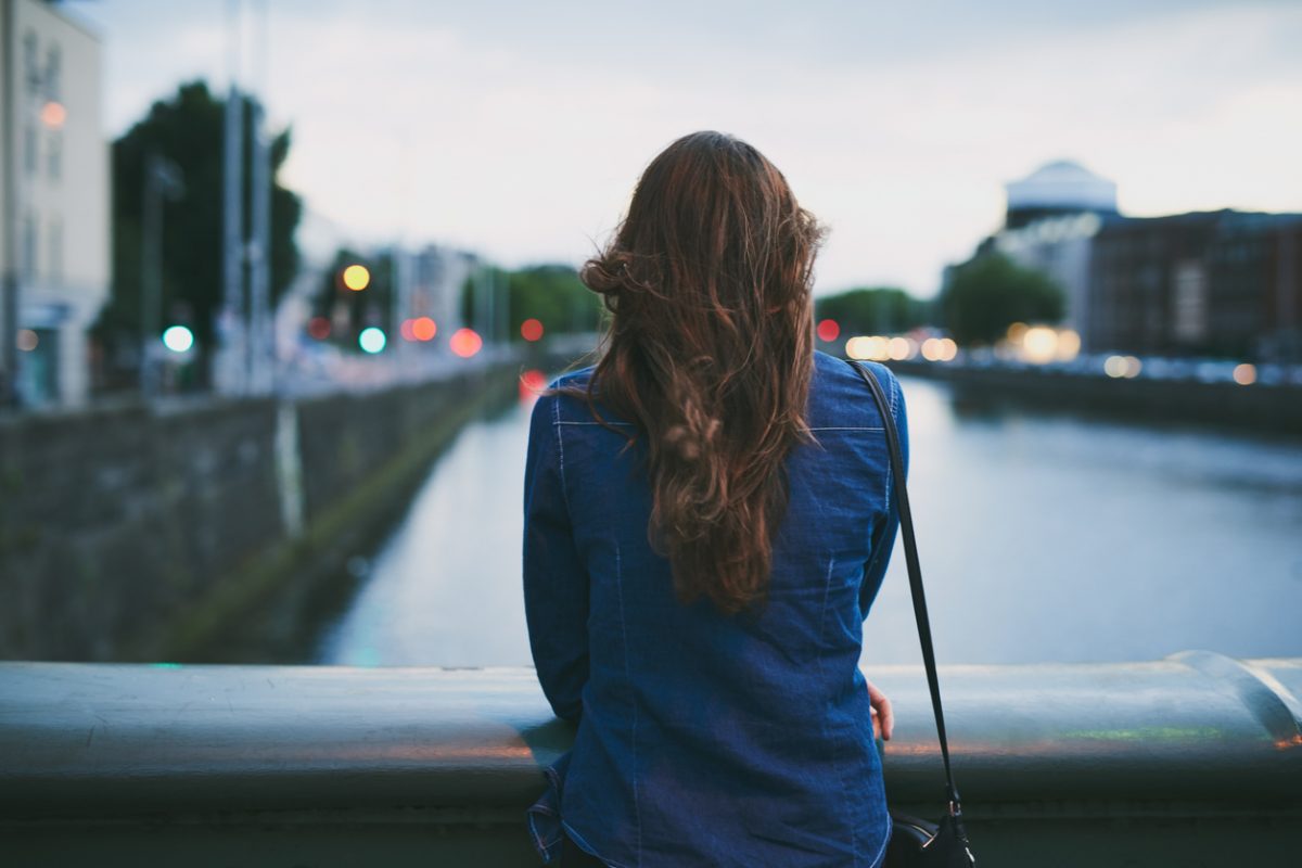 Rearview shot of a woman looking off into the distance.