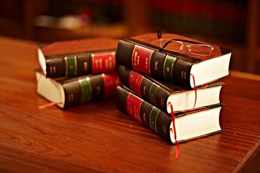 Stack of legal books on a desk in a law office.