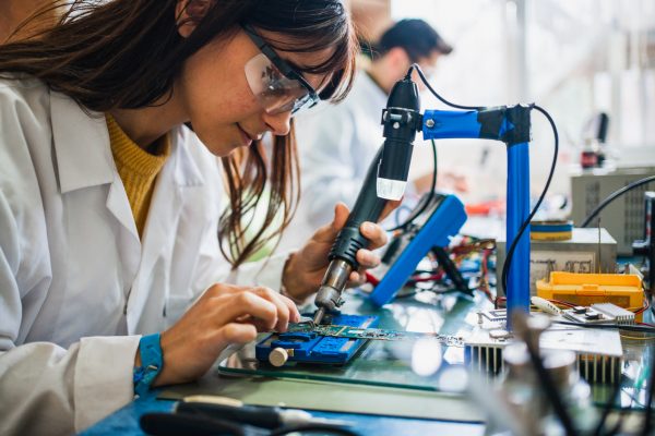 Student in a lab learning how to build robotics