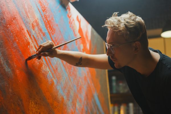 Portrait of an artist painting in his studio.