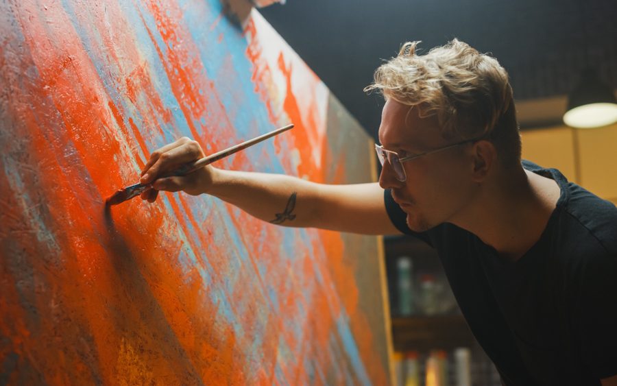 Portrait of an artist painting in his studio.