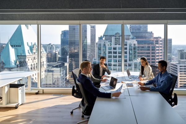 Young professional executives sitting for a board meeting.