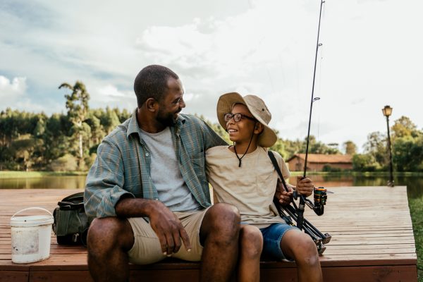 Father and son fishing in the lake relaxing and enjoying nature.