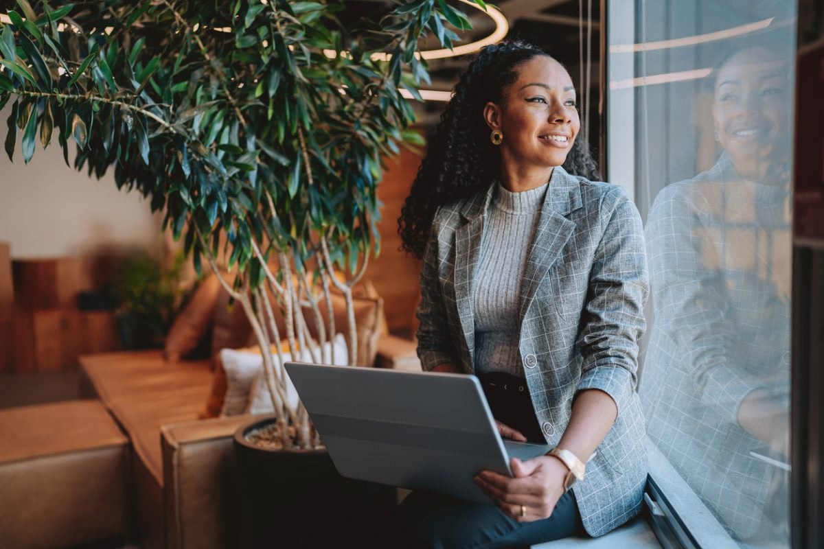 Startup worker looking up from her laptop in an office.