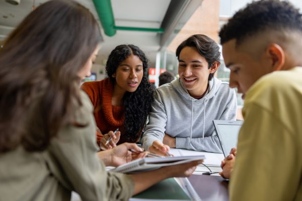 Group of young students working together at the library.