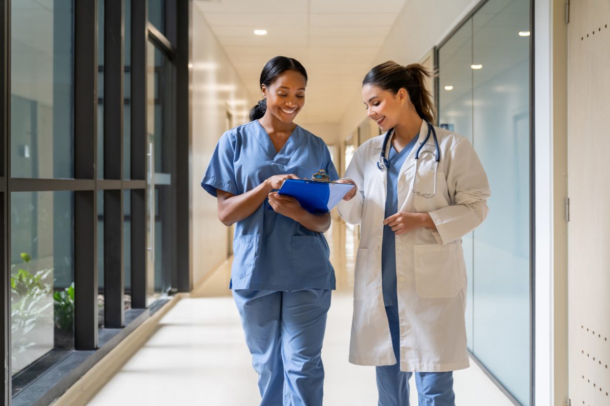 Doctor and nurse walking in a hospital hallway.