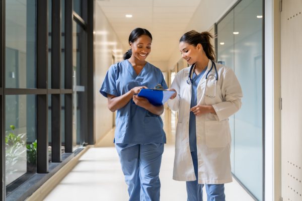 Doctor and nurse walking in a hospital hallway.